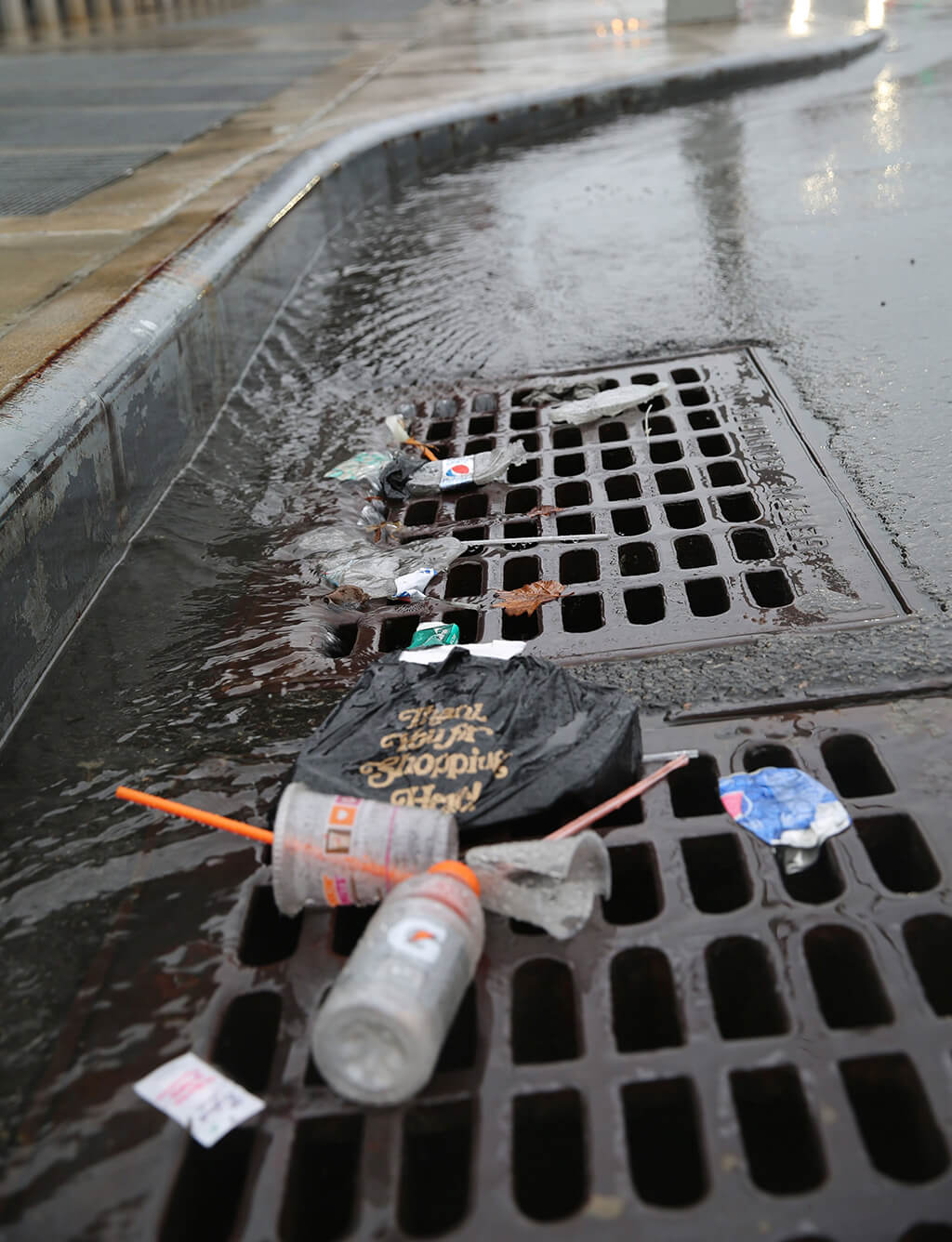 Trash in the drain on a street